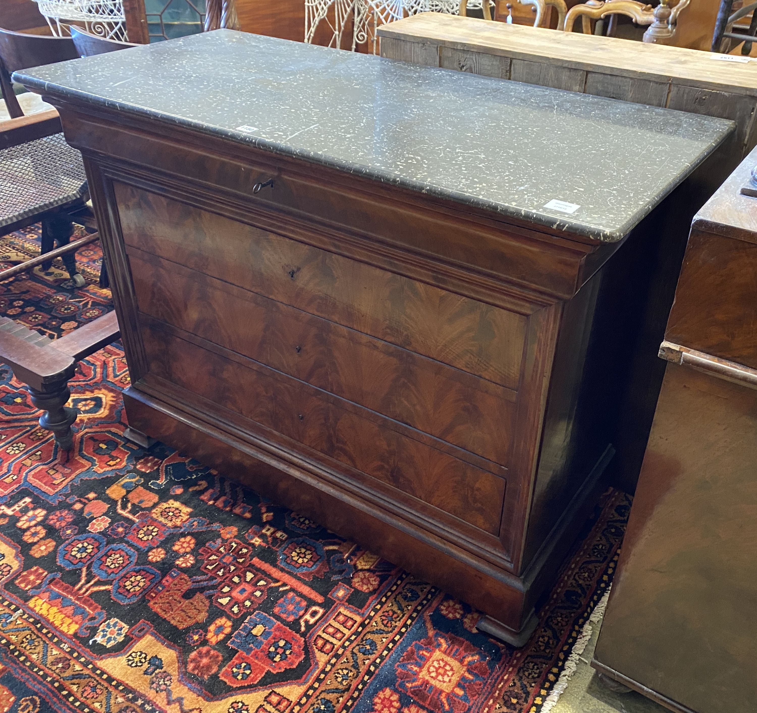 A 19th century continental flamed mahogany commode with black polished marble top, width 126cm, depth 58cm, height 95cm